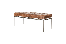 The Nasan Leather Upholstered Bench by nkuku features a tufted brown leather cushion and slim black iron frame. Visible stitching and buttons highlight its minimal, modern design, adding an industrial touch against a plain white background.