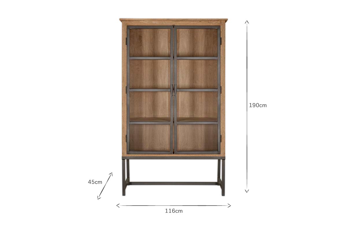The Nirvi Wood & Iron Cabinet - Black by nkuku features mango wood cabinetry, two glass doors, a black metal frame, four shelves, and stands 190cm tall, 116cm wide, and 45cm deep on a metal base against a white background.