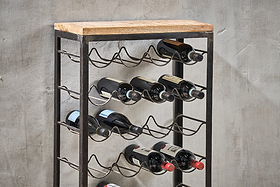 The nkuku Obra Industrial Wine Rack - Mango Wood & Iron - Large features wavy iron shelves and a mango wood top, blending rustic charm and industrial style while elegantly storing wine bottles against any wall.