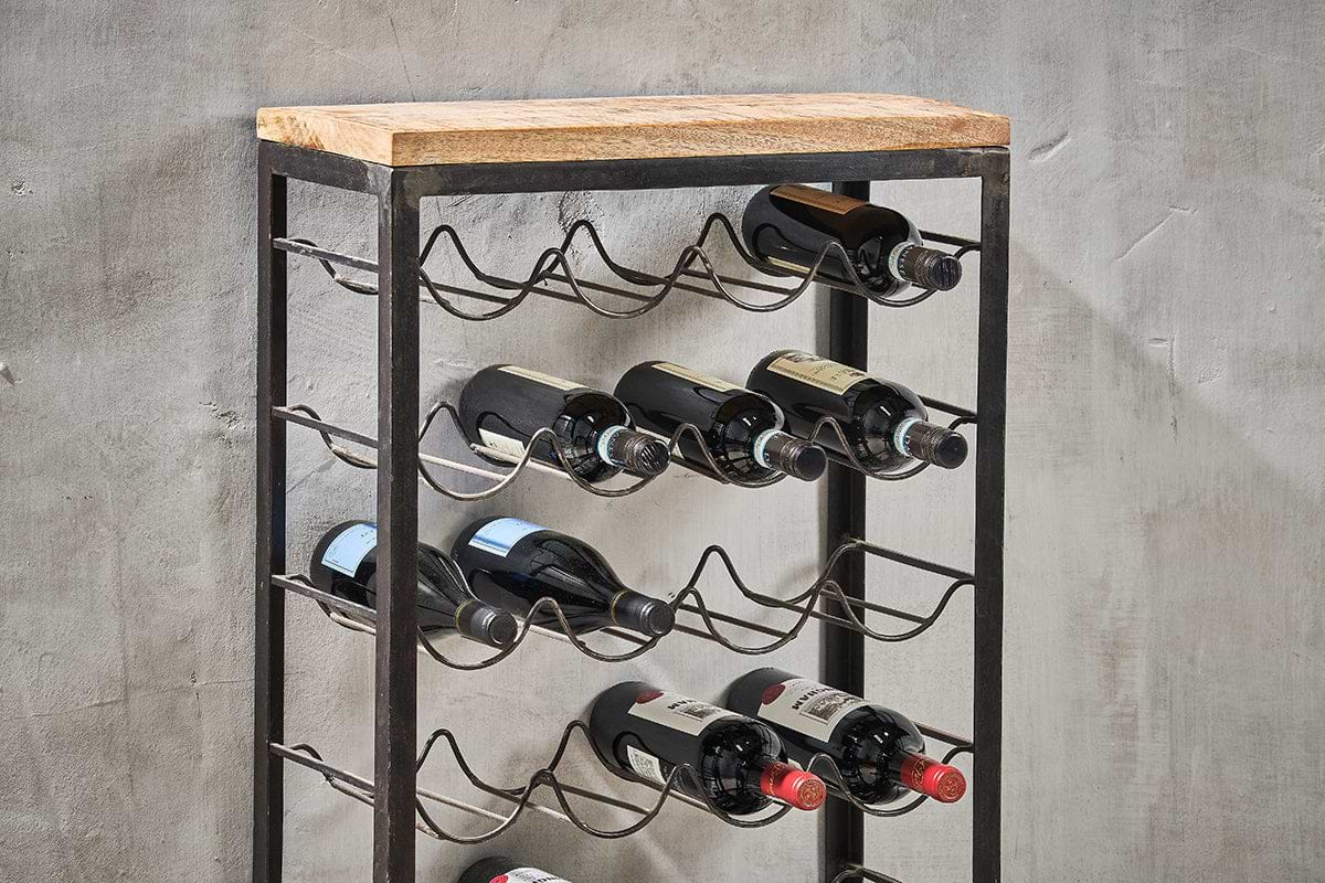 The nkuku Obra Industrial Wine Rack - Mango Wood & Iron - Large features wavy iron shelves and a mango wood top, blending rustic charm and industrial style while elegantly storing wine bottles against any wall.