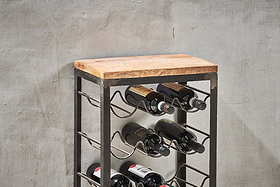 The nkuku Obra Industrial Wine Rack - Mango Wood & Iron - Small features a light brown mango wood top and sturdy iron frame, displaying bottles horizontally. Its modern design stands out against a textured gray wall.