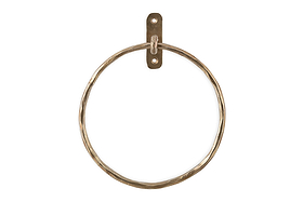 The Olani Towel Ring - Antique Brass by nkuku features a hammered brass finish and a rectangular wall plate with two screw holes, creating an elegant vertical towel holder perfect for any bathroom.