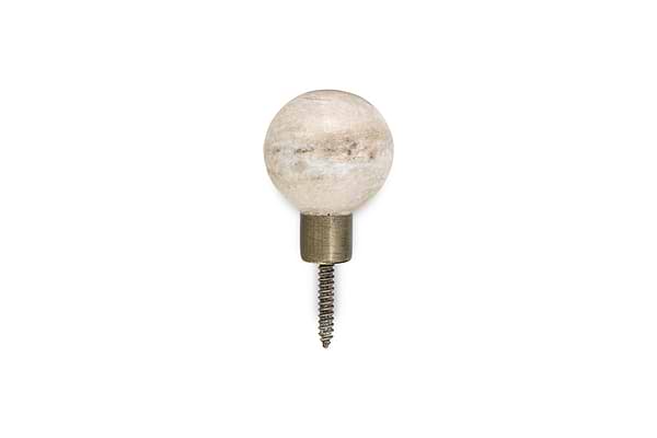The nkuku Paladi Marble & Iron Round Hook - Grey showcases a round marble knob with a brass-finished iron base and visible screw, offering hand-carved style and elegant simplicity against a white background.