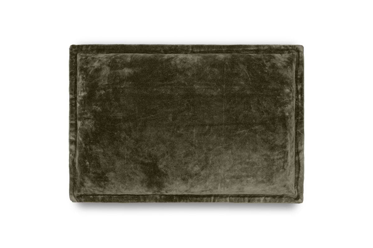 The nkuku Pilani Velvet & Linen Cushion Cover in Moss is a rectangular, deep green cushion cover with a smooth, plush velvet surface and stitched border, shown on a white background. It looks thick, soft, and elegant.
