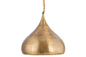 The Quinn Statement Hammered Metal Pendant - Large by nkuku features a teardrop shape, dimpled hammered brass surface, and antique brass finish, suspended from a gold chain for a warm, timeless look.
