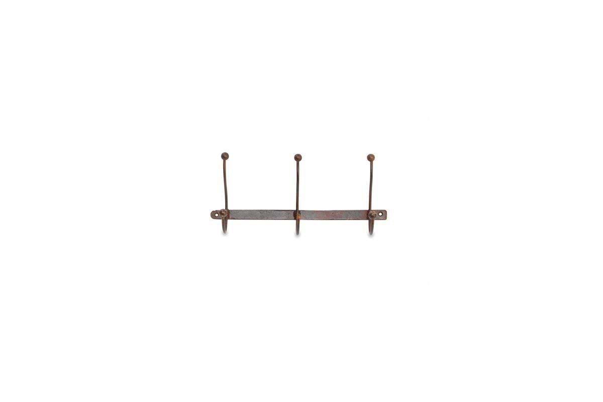 The nkuku Rama Iron Hook is a rustic, wall-mounted coat rack with three upward-curved iron hooks on a horizontal bar, featuring a weathered brown finish and mounting holes at each end. Shown against a white background.