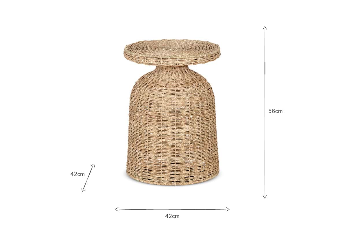 The nkuku Rampura Rattan Side Table - Natural features a handwoven rattan base and circular top. It measures 56cm tall by 42cm wide, with its natural fiber texture highlighted against a plain white background and measurement lines.