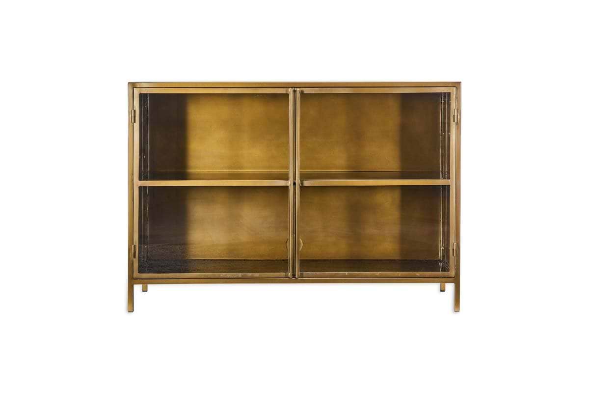 The nkuku Ranchi Iron Sideboard features a glass front, brass and glass construction, two shelves, and two doors, shown on a white background.