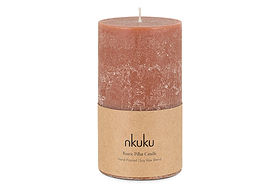 The nkuku Rustic Soy Blend Pillar Candle - Rust - Large is a reddish-brown, textured pillar candle with a short wick and brown paper label. Set against a white background, it’s hand-poured from a soy wax blend.