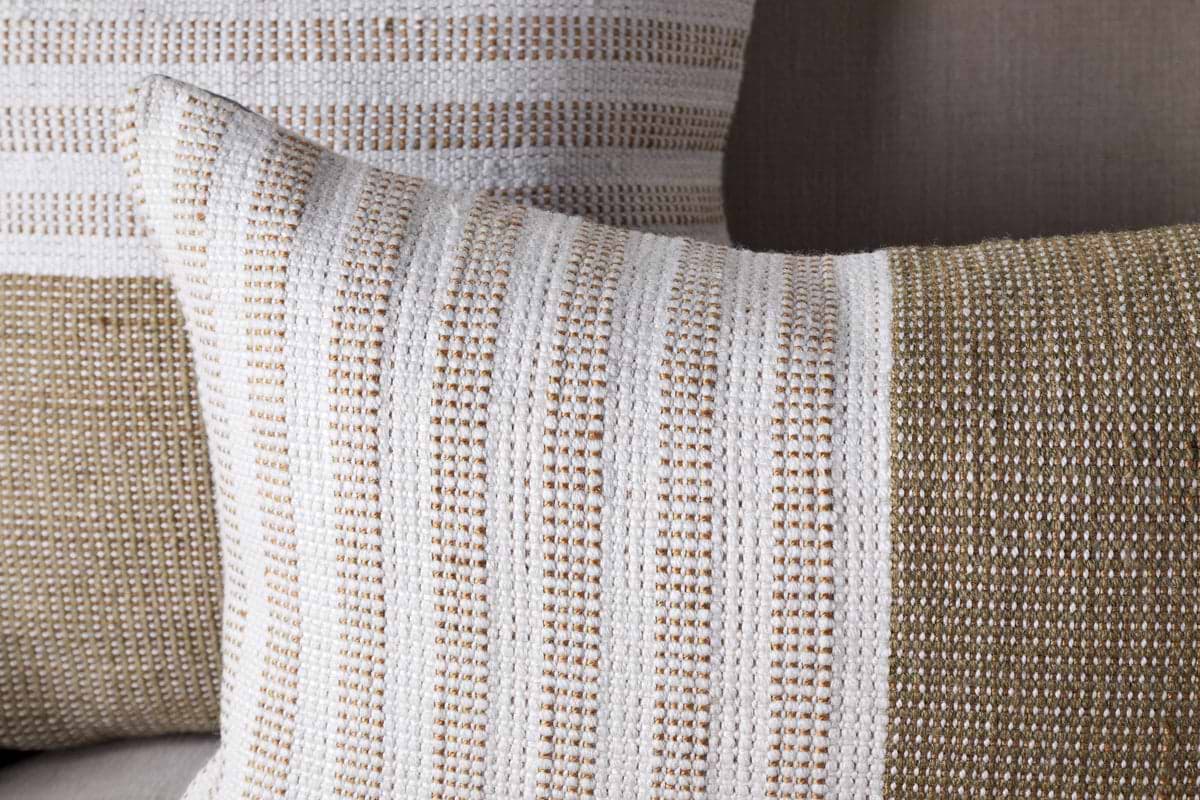 Two nkuku Samata Recycled Cushion Covers in moss, featuring textured horizontal stripes and a simple, modern design, are displayed against a beige background. Each cushion cover blends wide and narrow stripes for visual interest.