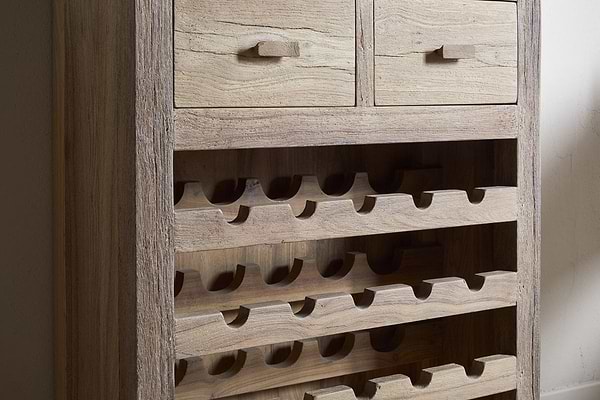 The nkuku Shanthi Reclaimed Wood Wine Rack - Natural features two top drawers and multiple horizontal slots for bottles, all crafted from natural, weathered wood for a rustic look.