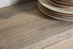 A close-up of reclaimed wood highlights its natural grain and texture, with the Shanthi Reclaimed Wood Wine Rack by nkuku offering perfect rustic style for unique wine bottle storage.
