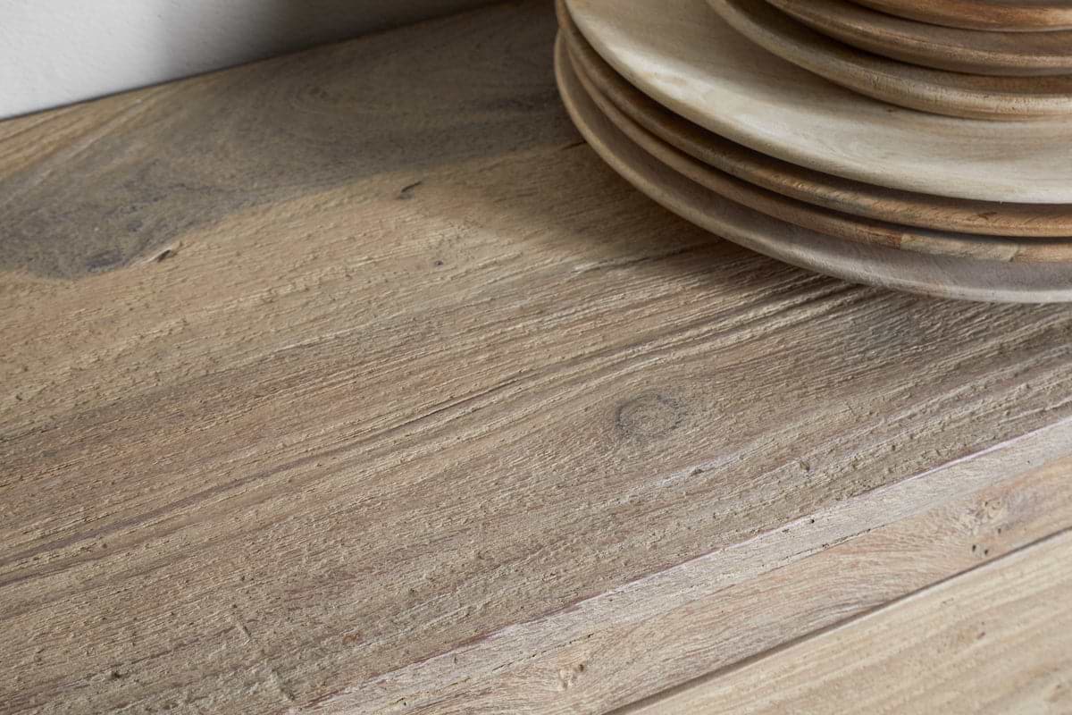 A close-up of reclaimed wood highlights its natural grain and texture, with the Shanthi Reclaimed Wood Wine Rack by nkuku offering perfect rustic style for unique wine bottle storage.