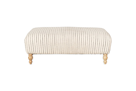 The nkuku Sanja Stripe Upholstered Ottoman in Off White features vertical black stripes on natural linen, four short turned wooden legs with a natural finish, and is showcased against a plain white backdrop for modern appeal.