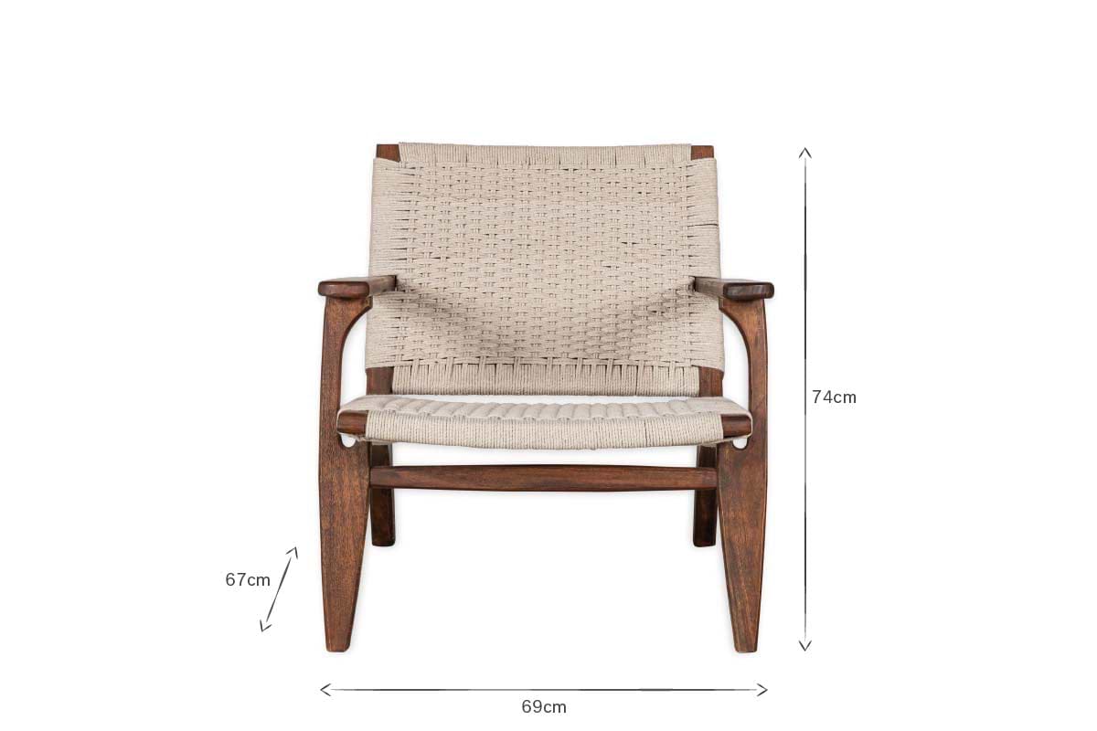 The nkuku Surat Woven Lounger - Natural features a wide acacia wood frame with hand-woven cotton rope seat and back. With angular armrests, sturdy legs, and dimensions of 74 cm high x 69 cm wide x 67 cm armrest height.