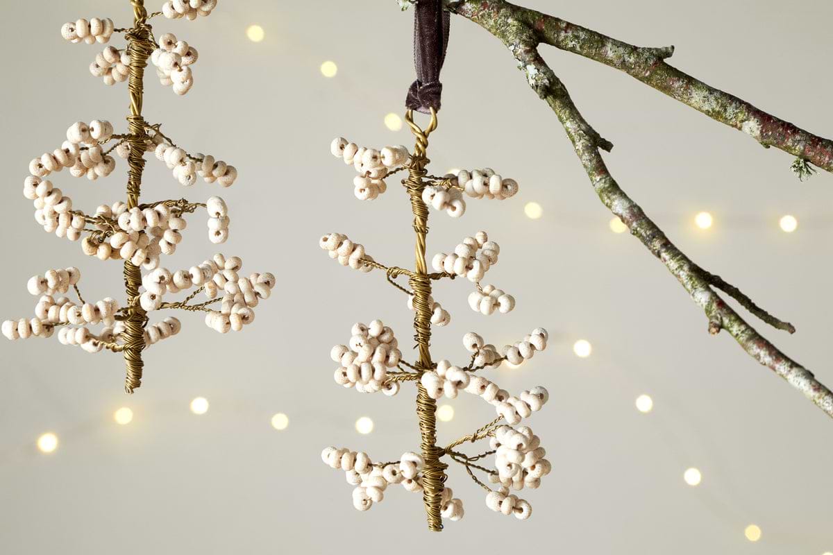 The nkuku Tanu Mango Wood Beaded Baubles - Brass & Natural (Set of 3) feature handmade berry-shaped ornaments with wood and brass beads, perfect for unique table decor or Christmas tree decorations, adding a warm festive touch.