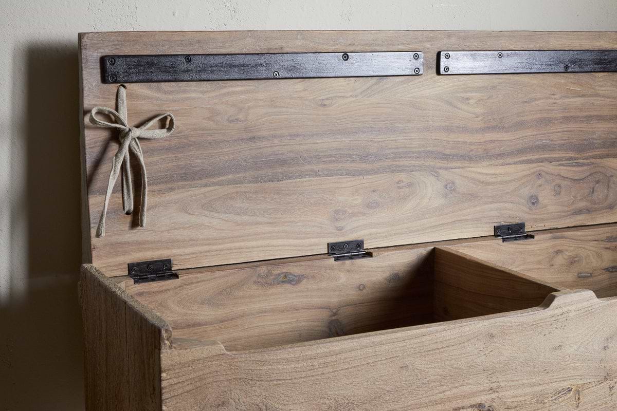 The nkuku Teni Reclaimed Wood Storage Bench with Upholstered Linen Cushion in Natural features a hinged lid, black metal strap, and twine bow. Its empty interior is divided into sections for organized storage.