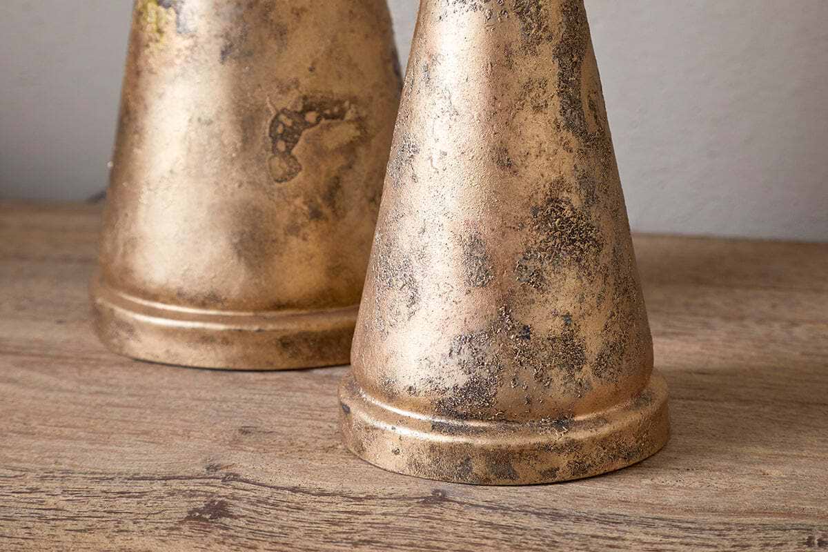The Talna Tree Bell - Antique Brass by nkuku features a weathered, gold-toned finish with dark mottled spots, resembling an antique brass bell—ideal as a unique festive ornament or Christmas decor.