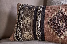 The nkuku Tussi Sia Cushion Cover in Dusty Pink features a textured woven design with geometric diamonds and zigzags, adding earthy tones to your space and perfectly complementing other Tussi cushion covers.