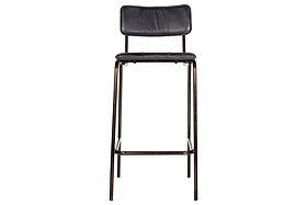 The nkuku Ukari Counter Chair - Aged Black features a curved back and rectangular seat in aged-black leather, set on a dark metal frame and legs for a modern, counter-height design.