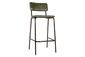 The Ukari Counter Chair - Rich Green by nkuku features a tall, cushioned seat and backrest in leather-like material, slender dark metal legs with a front footrest, offering a minimalist industrial style.