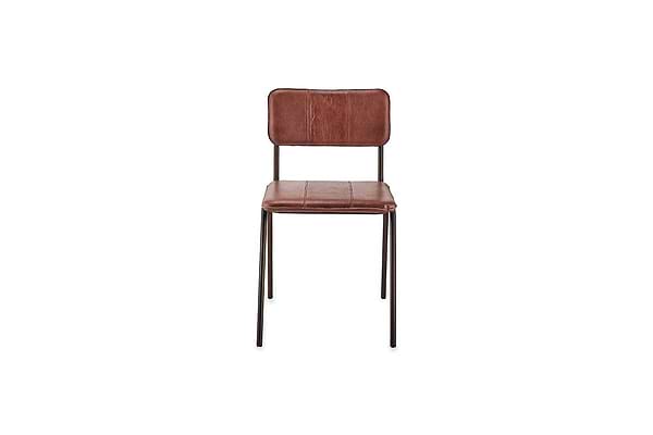 The nkuku Ukari Leather Dining Chair in chocolate brown features cushioned buffalo leather upholstery with stitching and thin black metal legs, making it a stylish choice for modern dining spaces.