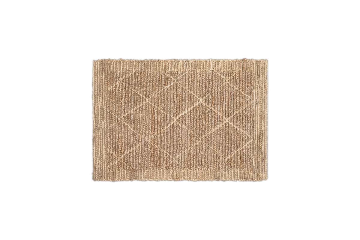 The Vandi Jute Doormat by nkuku is a rectangular, natural light-brown mat with a woven diamond pattern and slightly raised edges, displayed on a white background.
