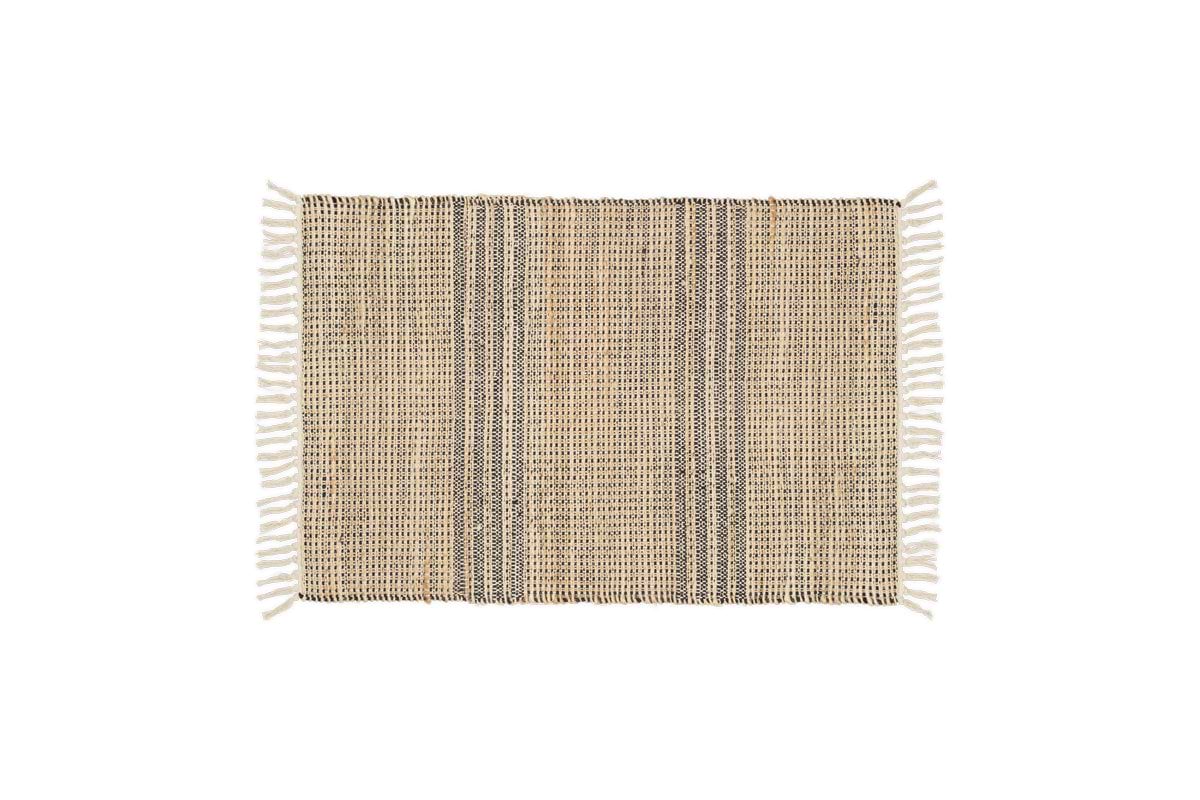 The Varli Jute & Cotton Doormat by nkuku features a handcrafted rectangular design with beige and dark brown vertical stripes, white fringes on the short edges, and is ideal as an indoor entryway mat. Background is plain white.