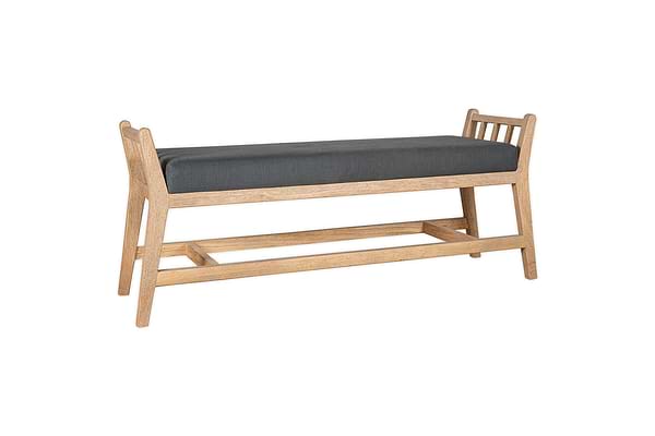 The Avanthi Upholstered Sleigh Bench by nkuku features a light natural wood finish, dark gray charcoal cushioned seat, slatted sides, open lower frame, gently angled legs, and a classic sleigh-inspired design.