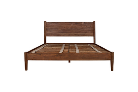The nkuku Anbu Acacia Bed in Washed Walnut features a sculptural, mid-century modern frame with a tall headboard and slatted base, shown from the front against a white background.