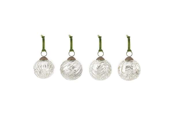 The nkuku Adoya Baubles - Aged Nickel (Set of 4) feature ribbed glass designs, each with a silver cap and green velvet tie, offering elegant festive decor against a plain white background.