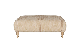 The Aranya Upholstered Ottoman - Natural by nkuku features beige cotton jute upholstery with subtle vertical stripes and four light wood legs, making it a perfect living room accent. Shown against a plain white background.