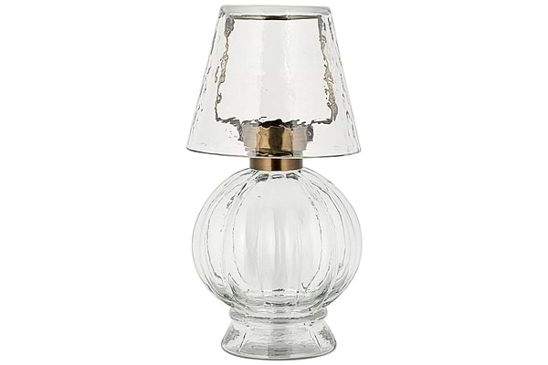 The Adesola Glass Tealight Holder Lamp by nkuku features a clear, textured glass base and matching shade with a metallic accent, offering stylish portable lighting.