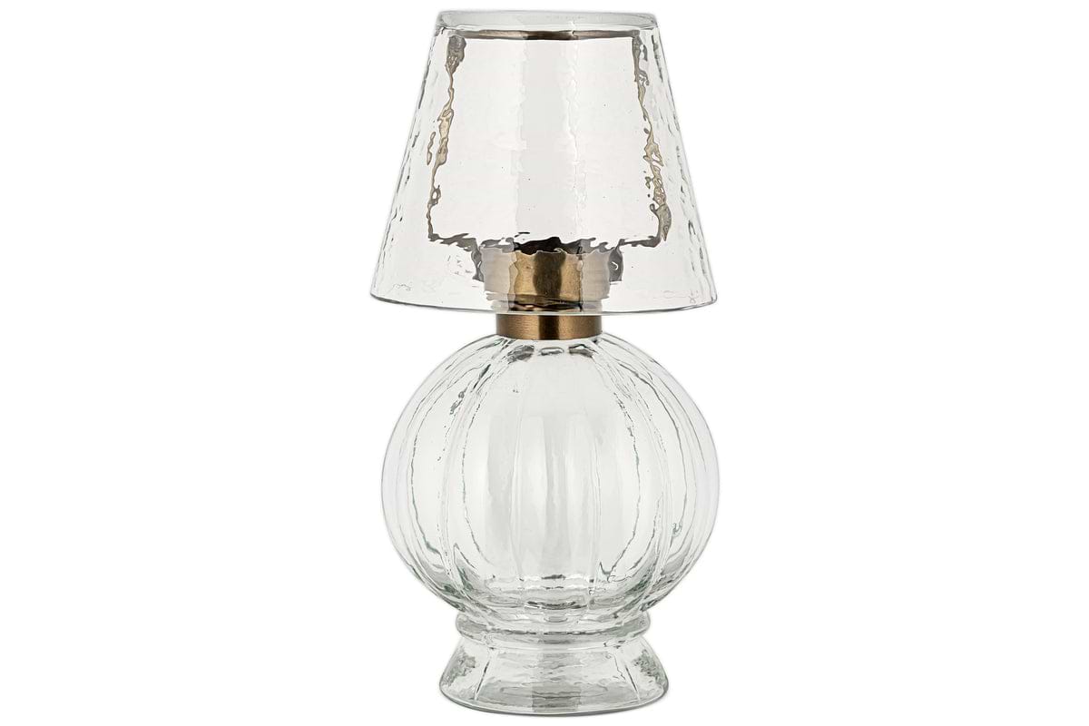 The Adesola Glass Tealight Holder Lamp by nkuku features a clear, textured glass base and matching shade with a metallic accent, offering stylish portable lighting.