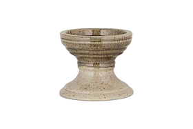 The Cabra Reactive Glaze Candle Holder by nkuku features a wide bowl, ribbed detail, and flared base. Its olive and natural reactive glaze offers a rustic look. The candle holder is centered on a plain white background.