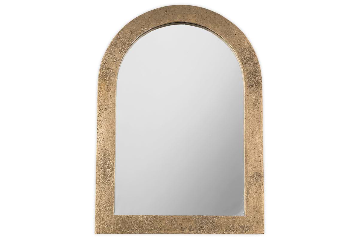 The Cayce Cast Aluminum Vanity Mirror by nkuku features an arched design with a wide, textured antique brass frame, shown against a white background.