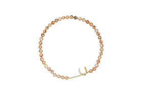 The Cerita Necklace - Rhodochrosite by nkuku features round, marbled beige and peach semi-precious stones with a gold chain extender and clasp, offering a versatile accessory.