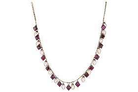 The Ekiti Bauble Garland - Ruby & Copper by nkuku features a fine gold chain with alternating ruby and copper gemstone pendants in square and teardrop shapes, inspired by vintage decor and the classic Ekiti bauble garland.