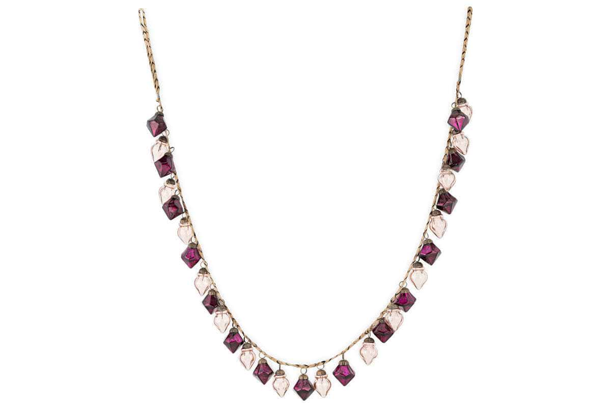 The Ekiti Bauble Garland - Ruby & Copper by nkuku features a fine gold chain with alternating ruby and copper gemstone pendants in square and teardrop shapes, inspired by vintage decor and the classic Ekiti bauble garland.