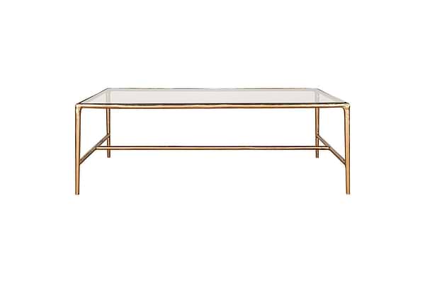 The nkuku Gilasi Cast Metal & Glass Coffee Table features a minimalist, modern design with a rectangular glass top and slim, antique brass metal frame and legs, shown against a white background.