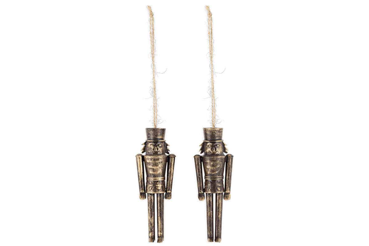 The Imay Nutcracker Baubles - Antique Brass (Set of 2) by nkuku feature metal figures with an antique gold finish and rustic twine loops. Each mini bauble has a tall hat, simple features, and straight limbs—ideal festive décor for your Christmas tree.