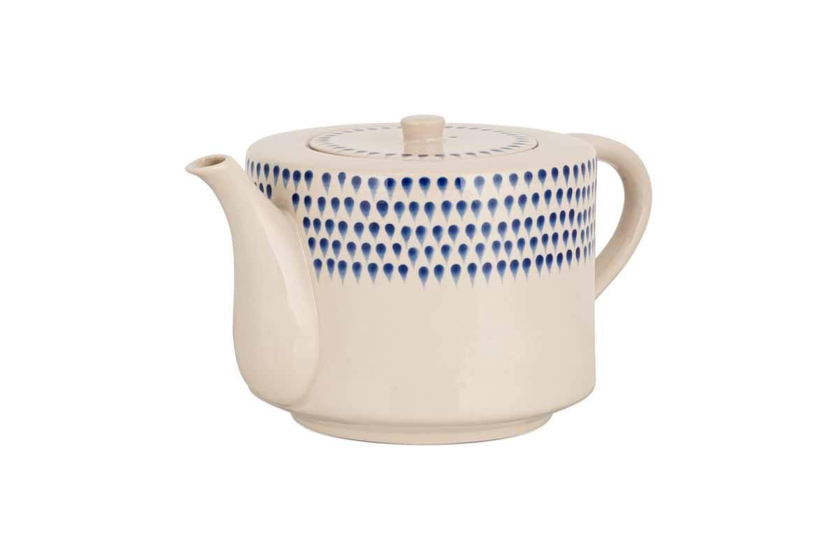 The nkuku Indigo Drop 4 Person Teapot - Cream & Indigo features a cream ceramic finish, curved spout and handle, and hand-painted blue teardrop design—combining modern style with function, its perfect for gifting to tea lovers.