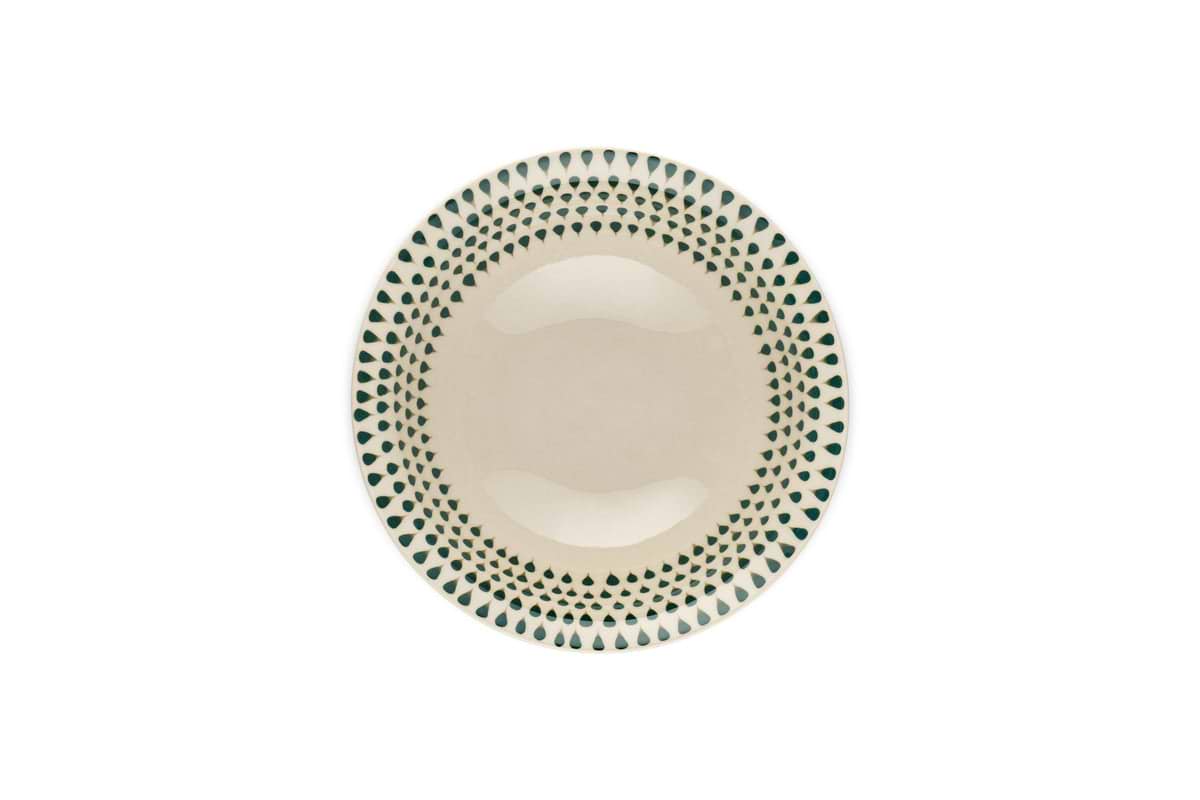 The Juniper Drop Cereal Bowl by nkuku features a cream ceramic finish with a green drop pattern around the rim, perfect for everyday use and shown from above on a white background.