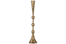 The nkuku Javanee Candle Holder in antique brass is tall and slender, with a flared base and top, showcasing sculptural elegance through two rounded, bulbous sections along its stem.