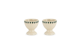 The nkuku Juniper Drop Egg Cups in cream & juniper (set of 2) feature a green drop design around the rim—perfect for brightening up your breakfast table.