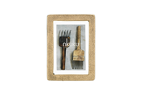 The Jahala Wall Hung Photo Frame by nkuku features an antique brass thick frame and displays two rustic metal tools on a light background, with “nkuku” centered in the image.
