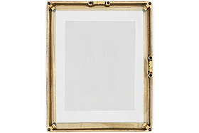 The Jahala Wall Hung Photo Frame by nkuku features a rectangular antique brass frame with decorative ridges and black screws at the corners and sides, and includes a white mat. Shown empty against a white background.