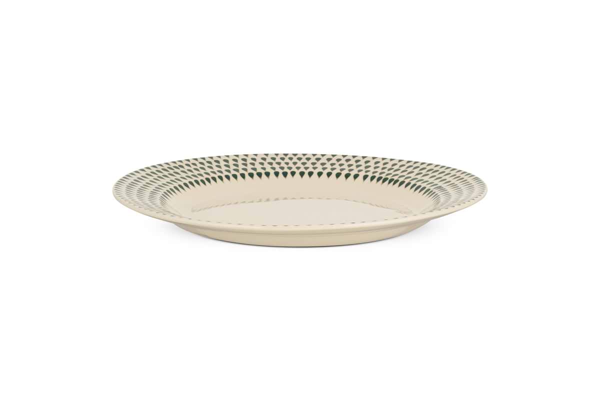 The Juniper Drop Dinner Plate - Cream & Juniper by nkuku features a round, cream ceramic design with a blue geometric rim, showcasing modern tableware style against a white background.