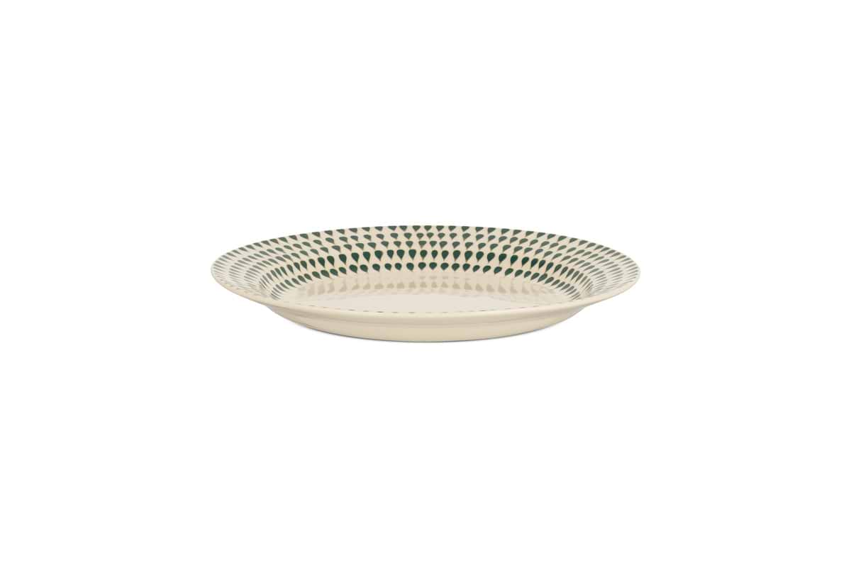 The nkuku Juniper Drop Side Plate in Cream & Juniper features a shallow, round ceramic design with a cream base and evenly spaced dark green dots around the rim, shown on a plain white background.