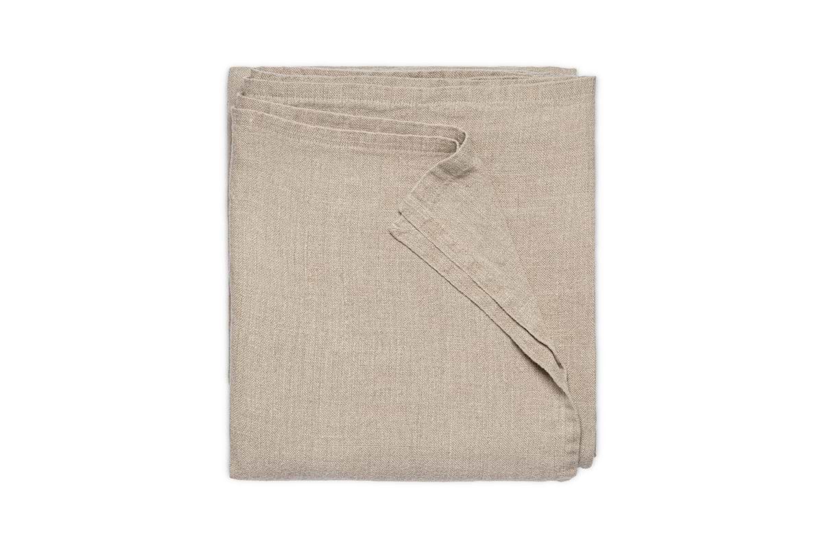 The nkuku Junto Linen Tablecloth in Natural (Small) is neatly folded and displayed against a plain white background.